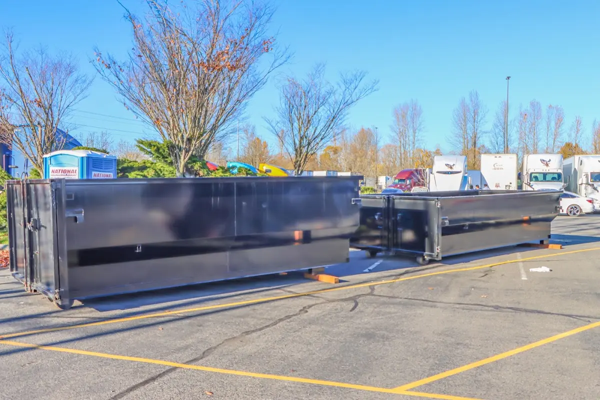 Professional dumpster rental service with roll-off container on residential driveway in Fond du Lac